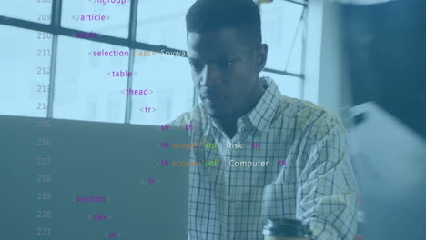 working in modern office, man coding with colorful animation overlay on laptop