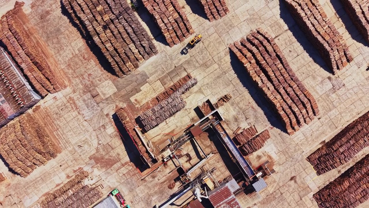 Log storage area with processing equipment and machinery