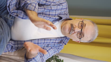 Vertical-video-of-The-old-man-says-wow-to-the-camera.