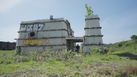 hombre buscando estructura abandonada y en ruinas, edificio inestable y peligroso