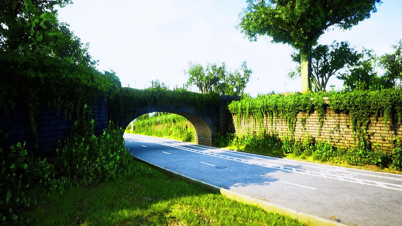 Scenic view of a lush green archway bridge on a tranquil road