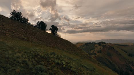 Aerial-of-backcountry-mountain-range-at-sunset-with-beautiful-cloud-formation-after-a-storm