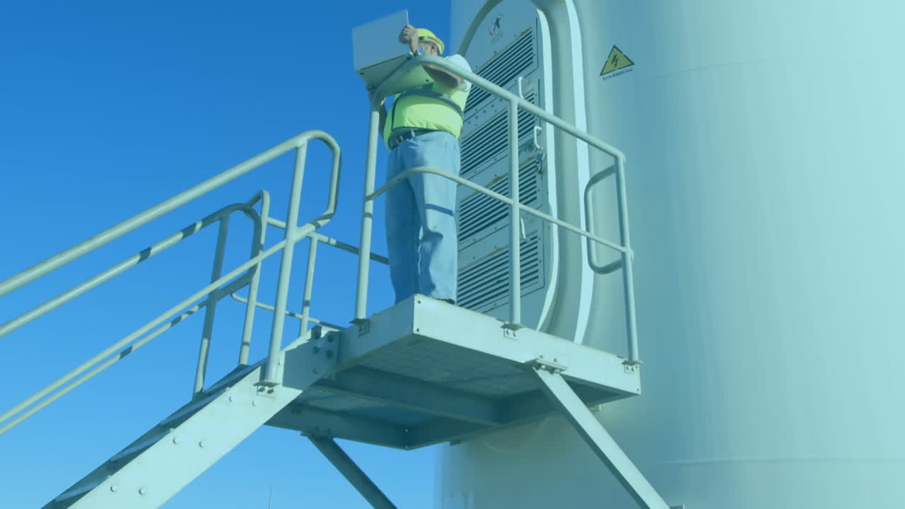 animación de procesamiento de datos estadísticos contra un ingeniero masculino usando una computadora portátil cerca de un molino de viento