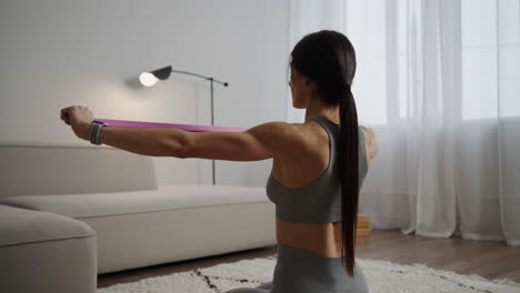 woman doing resistance band exercises at home