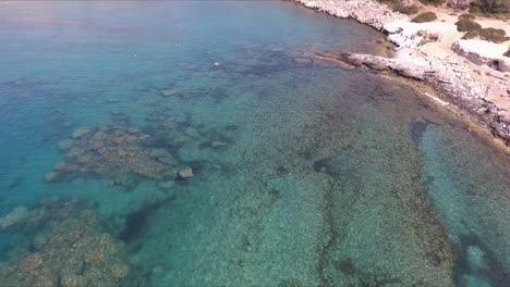 a shot of the ocean shallows and swimmers on the greek island of rhodes