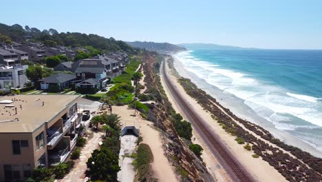 aerial shot of delmar coastline panning backwards with