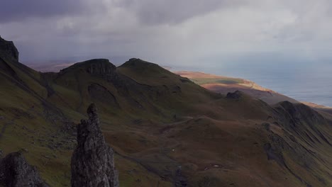 aerial drone flyover of old man of storr and sea in skye scotland autumn