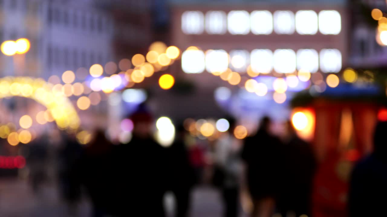 Night City Boke Lights. Festive Illumination, Natural Defocused Blurred Bokeh Background Effect Of Traditional Christmas Trading Houses In Winter Evening Night In Festive Lighting