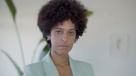 portrait shot of young curly african american woman indoors