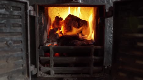 Static-close-up-shot-of-small-chimney-burning-wood-in-yellow-flames-in-house