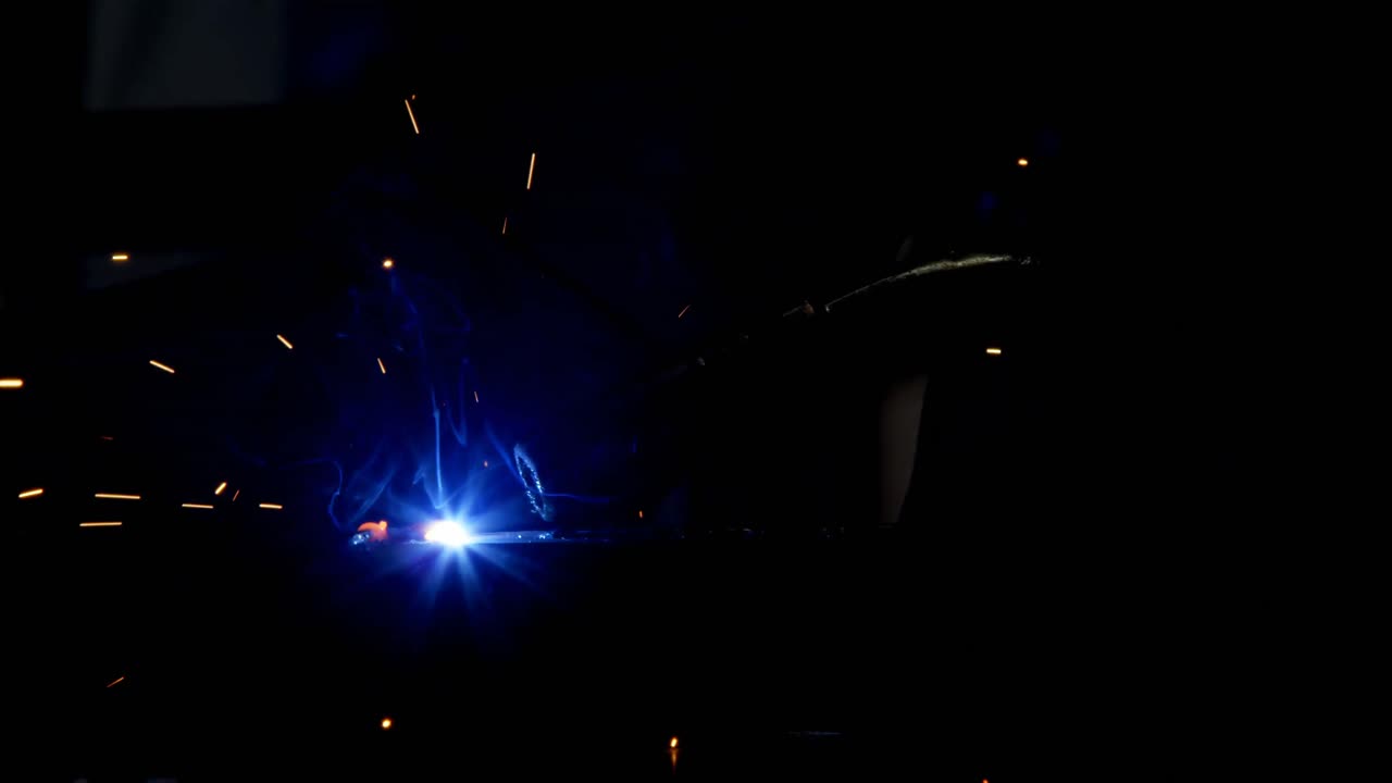 Female welder using blowing torch on a rod 4k
