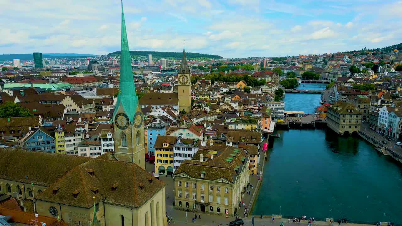 4K Drone Video of the Historic Grossmünster Church and Opera House on the banks of the Limmat River in Downtown Zurich, Switzerland
