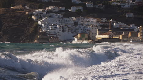 powerful waves crashing on a coastal town