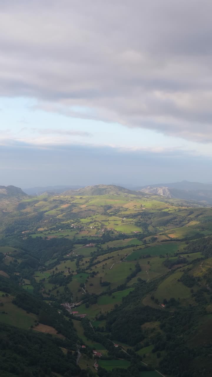Scenic green valley landscape under cloudy sky. Vertical