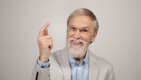 Cheerful-man-snapping-fingers-inside.-Aged-businessman-looking-camera-indoors.