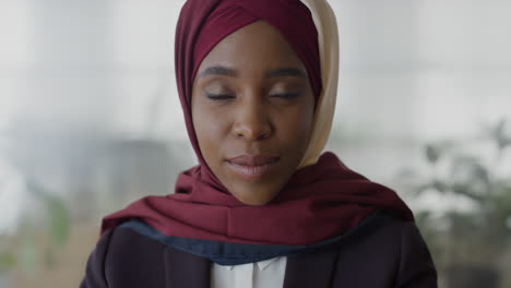 close up portrait beautiful black business woman smiling confident professional african american muslim female wearing hijab headscarf slow motion