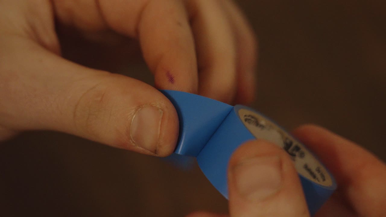 Attempting to rip off tape from roll