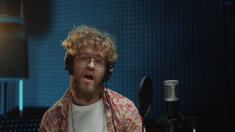 Close-Up-Of-The-Young-Stylish-And-Attractive-Guy-Singer-Recording-His-Solo-Vocal-And-Singing-In-The-Microphone-At-The-Studio