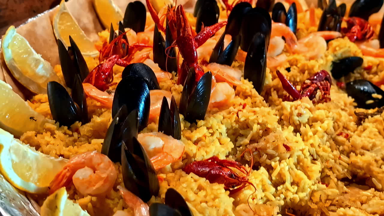 Seafood Paella With Mussels, Prawns And Slices of Lemon. - closeup shot