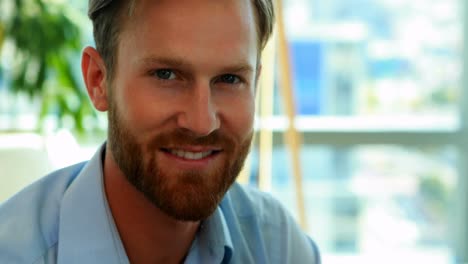 handsome businessman smiling at camera