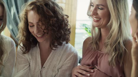 group of female friends looking an ultrasound scan result and enjoying the time together.