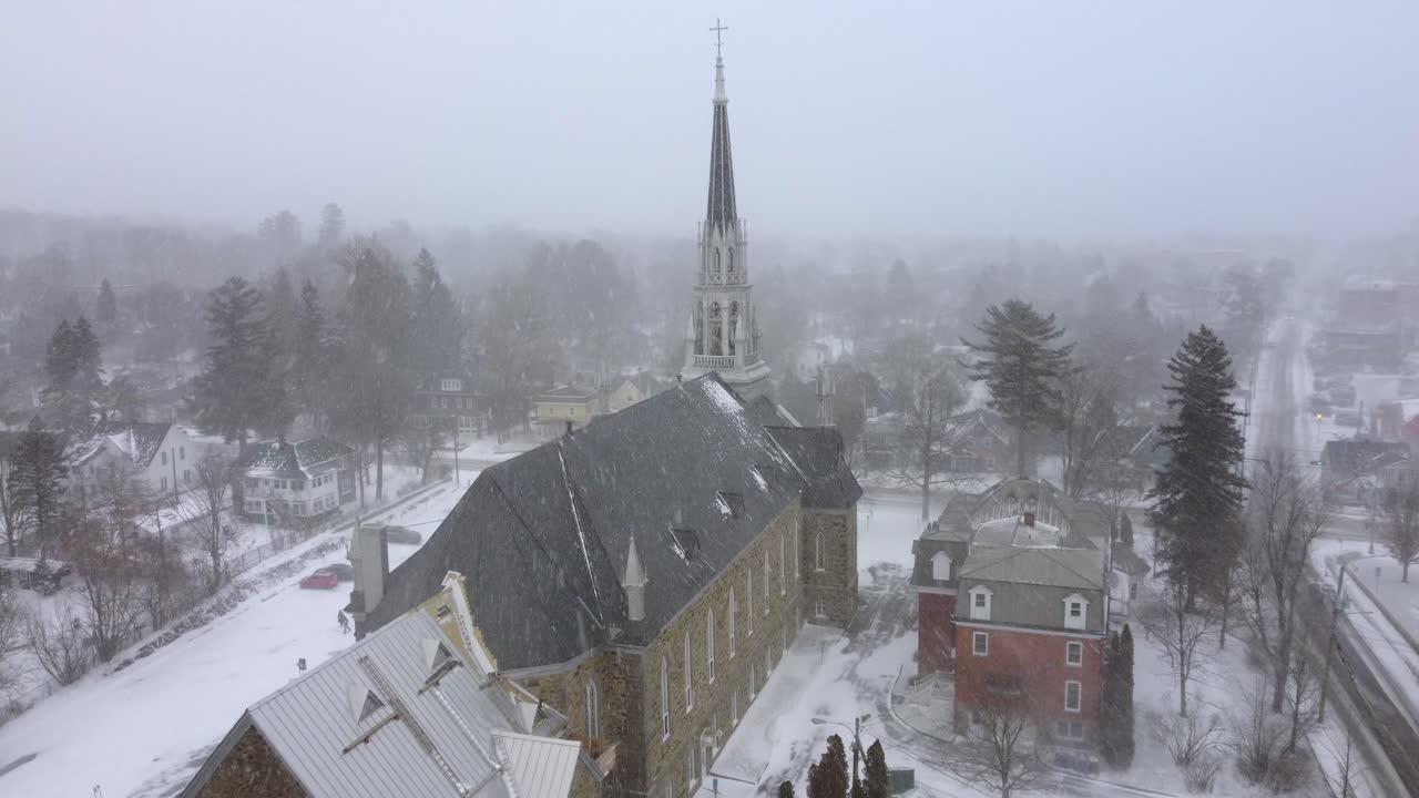 Snowy covered old church in thick fog with barely visible, Orford, Quebec, Canada