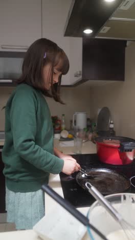 young girl cooking in kitchen