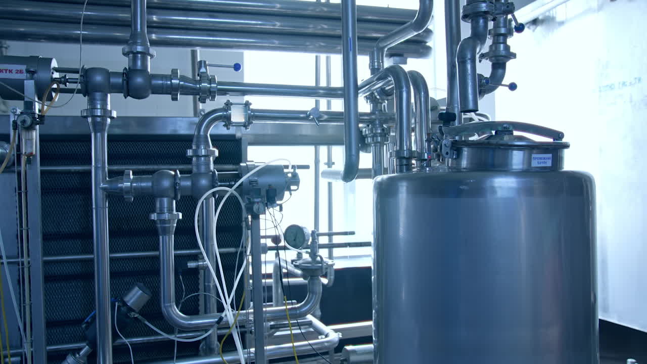 Modern milk factory with stainless tubes. Steel huge diary factory technologies.