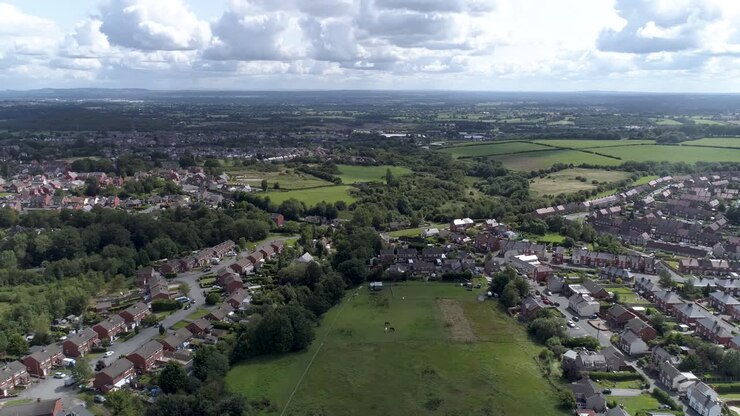 Left to right aerial shot above town near Wrexham, North Wales