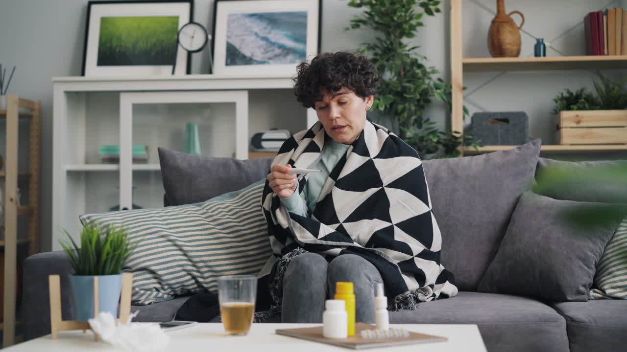 Woman Checking Temperature at Home