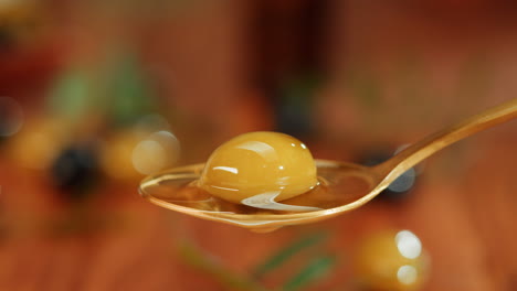spoonful of olives with dripping olive oil