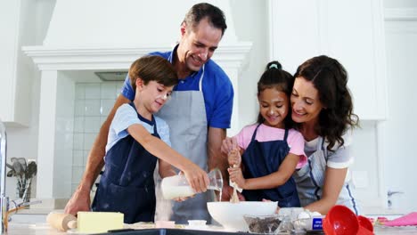 Happy-family-preparing-cookies-in-kitchen