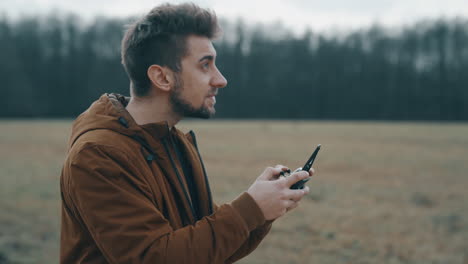 Young-man-flying-a-drone-outside