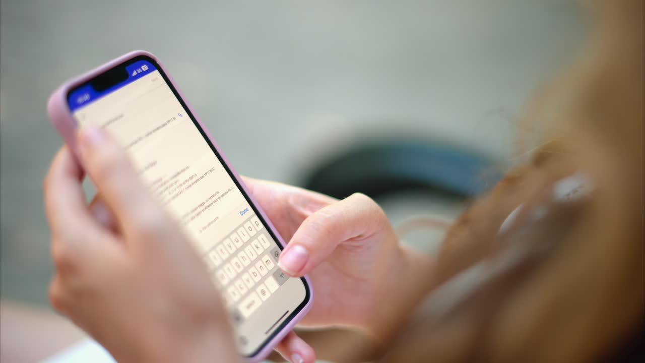 Woman replying to an e-mail on her phone