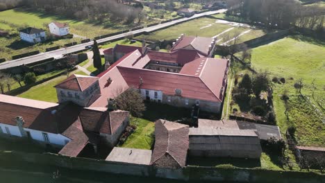 drone orbits around top of monastery roof as sunlight glistens from sun high in the sky