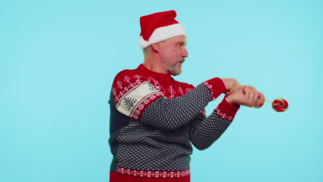 Joyful-man-in-red-Christmas-sweater,-hat-holding-candy-striped-lollipops,-dancing-making-silly-faces