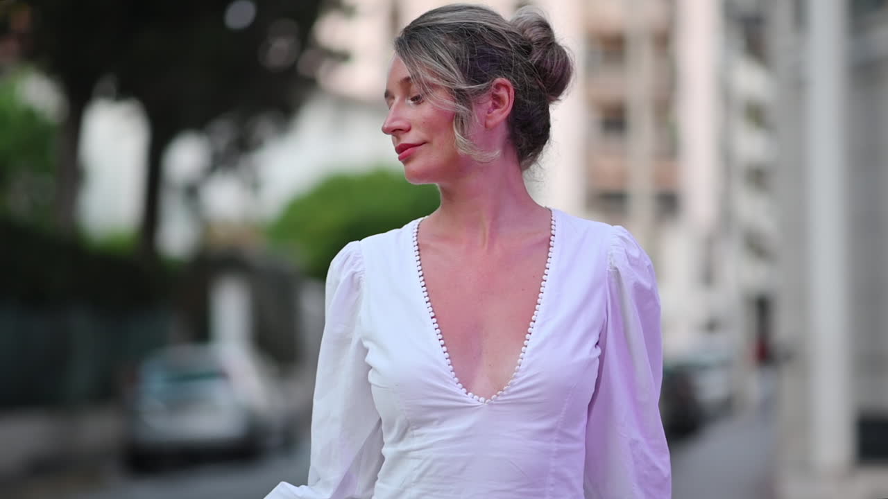 Woman in white dress posing in Cannes, France
