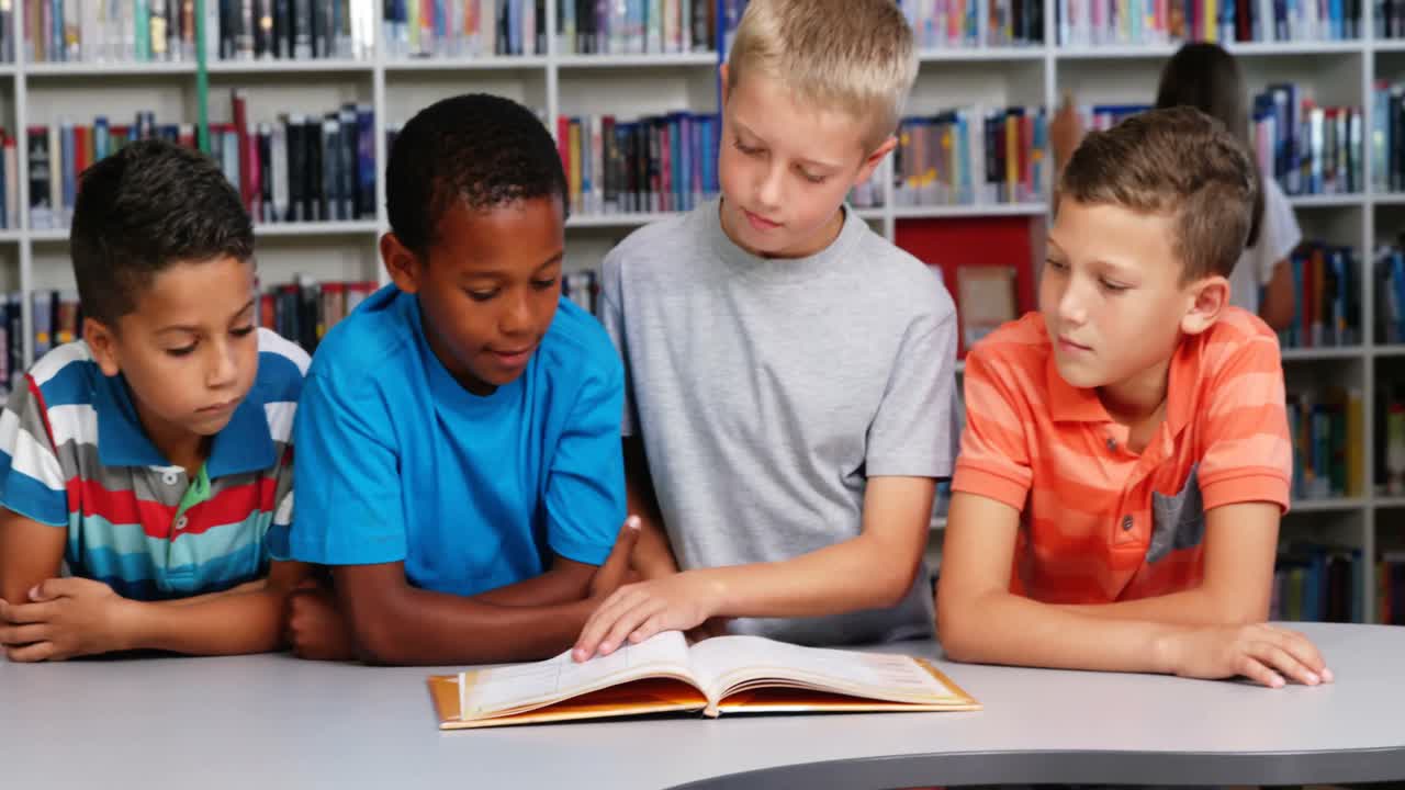 School kids reading book together in library