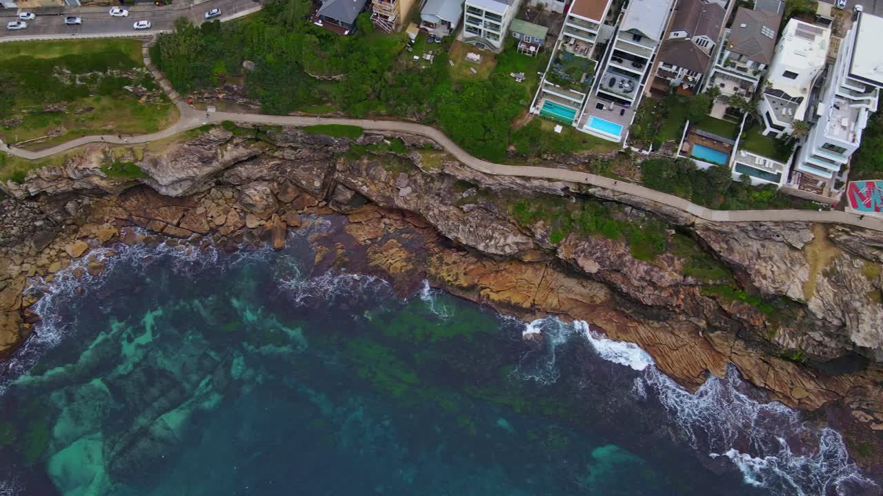 호주 뉴 사우스 웨일즈에 있는 매켄지스 베이의 바위가 많은 해변에 건물 구조