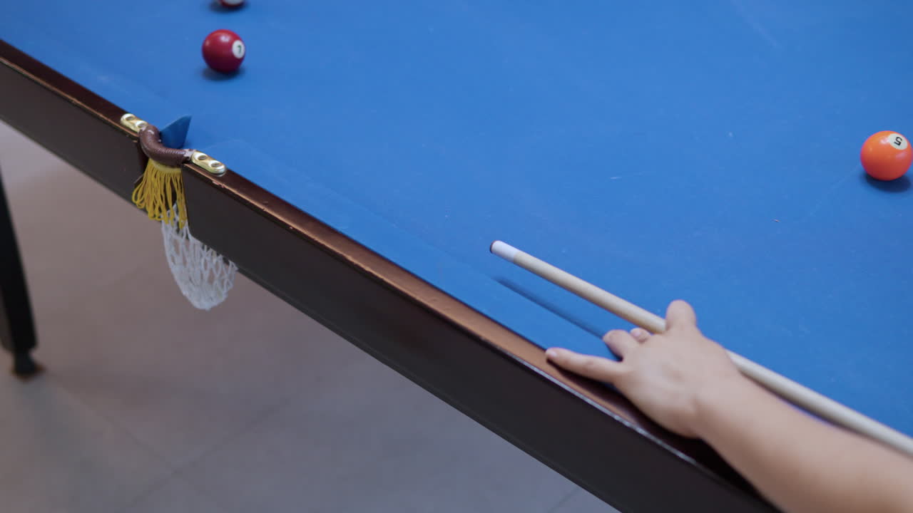 Girl's Hand Close-up Aiming and Hitting White Cue Ball Leaning on Rail