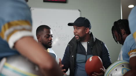 football coach giving instructions to his team