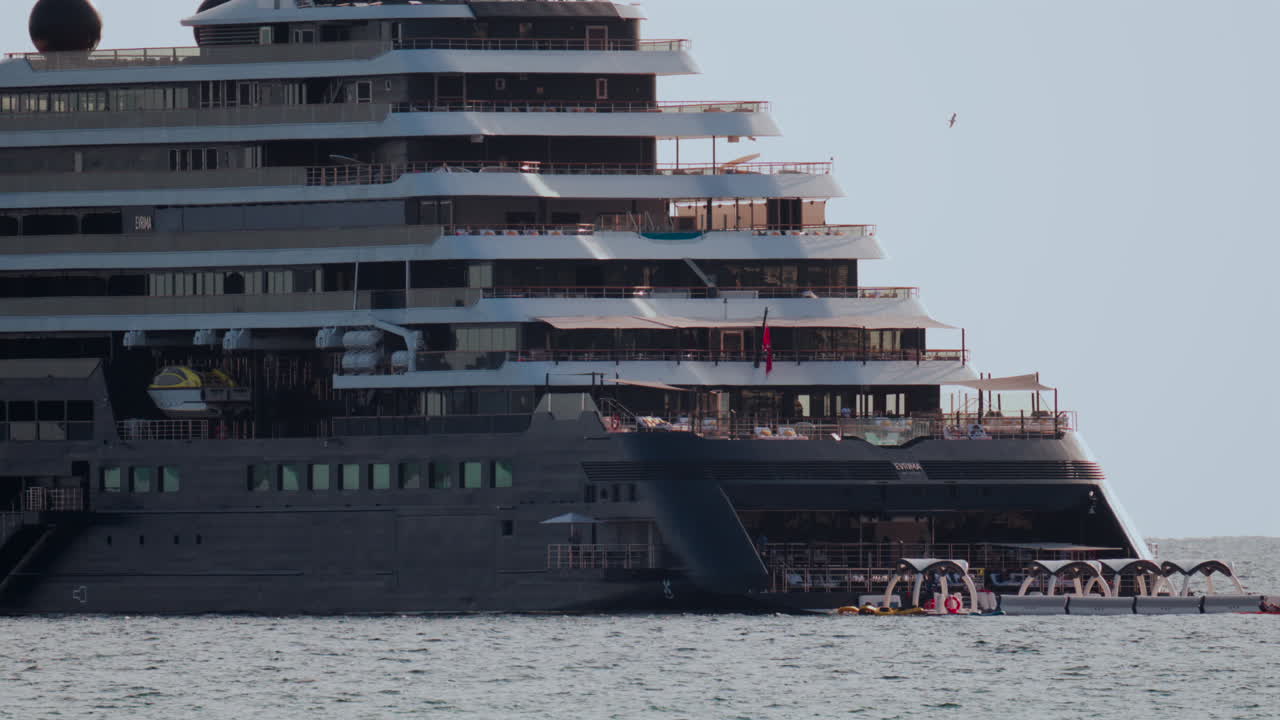Cannes, France - October 4, 2025: Massive luxury cruise ship sailing on calm sea under pale sky