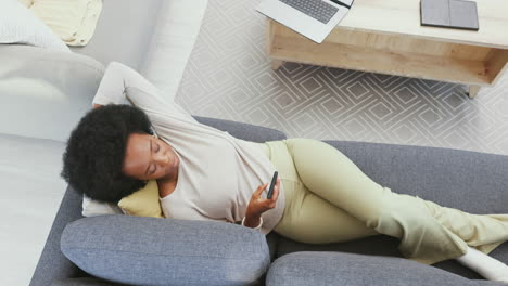 relaxed woman using a phone to browse online