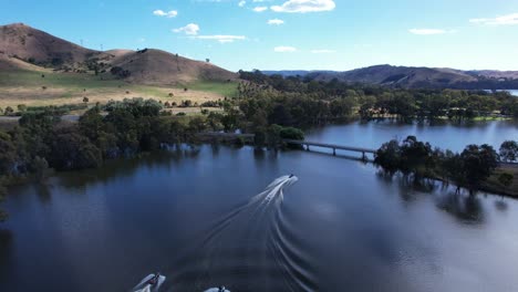 Jet-skis-cruising-on-beautiful-Lake-Eildon-aerial-tracking