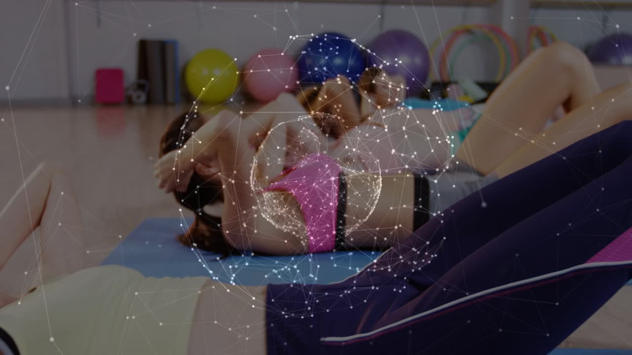 Women following class cue, crunching on blue mats in fitness class, globe overlay pulsing over abs