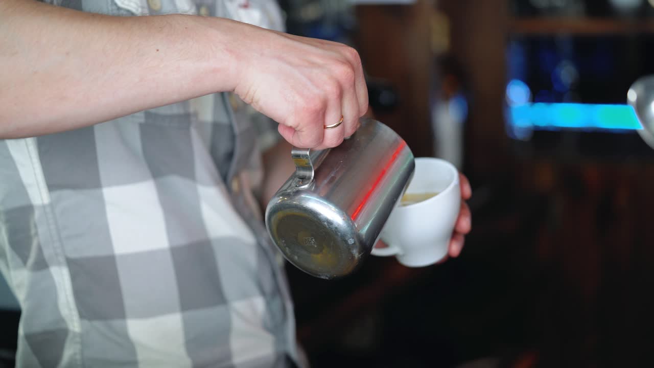 Barista drawing the heart on the coffee. Concept of services and beverages.