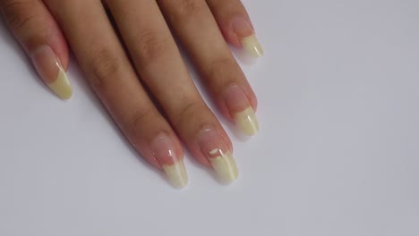 Female-hand-with-long-natural-nails-with-Topcoat-on