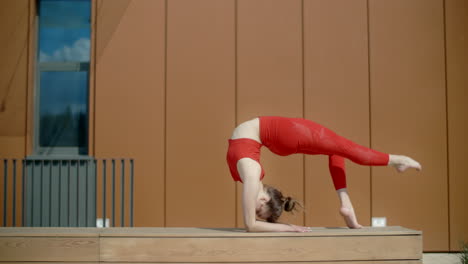 woman performing acrobatics yoga poses outdoors