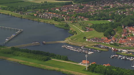 smooth flight over dutch waterlands in summer turning around a little village