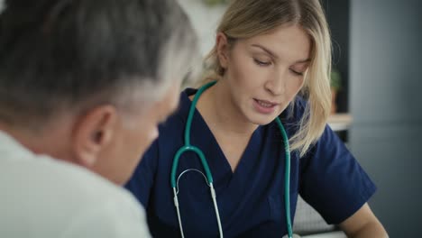 caucasian female doctor at the home visit.